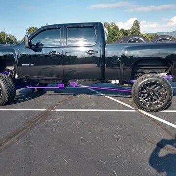 Pro Form Fab traction bars installed on a lifted diesel pickup