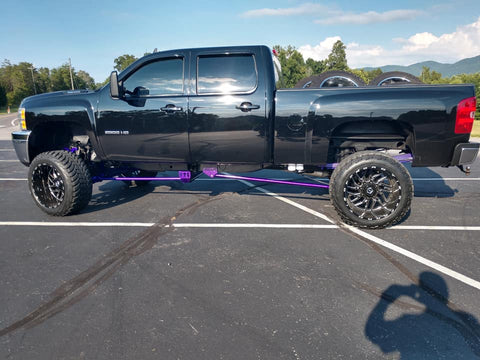 Pro Form Fab traction bars installed on a lifted diesel pickup