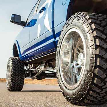 All-terrain tires mounted on a lifted diesel pickup truck
