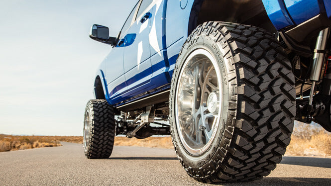 All-terrain tires mounted on a lifted diesel pickup truck